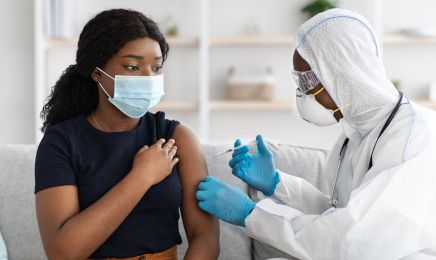 Woman getting a vaccination jab